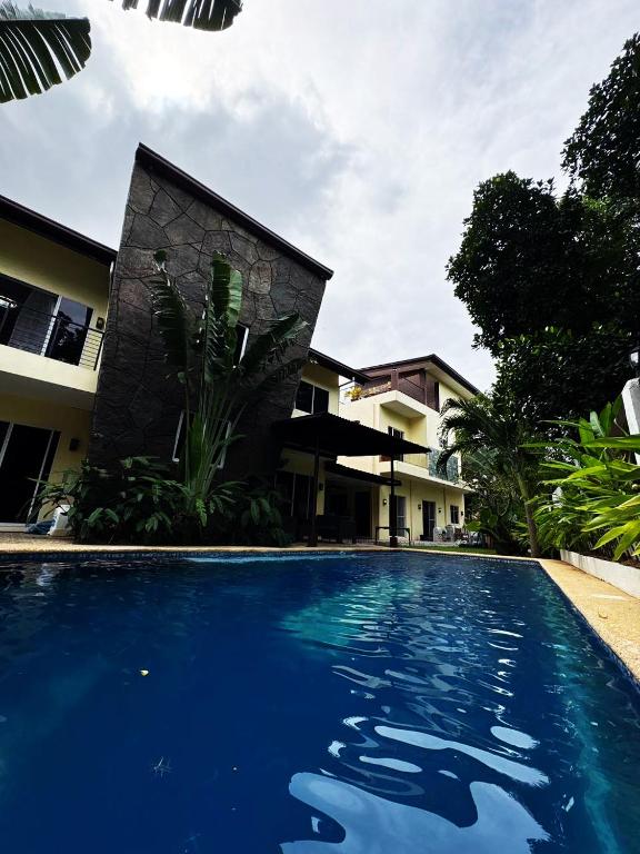 a large blue swimming pool in front of a building at The Transient Villa Hotel and Suites in Cordova