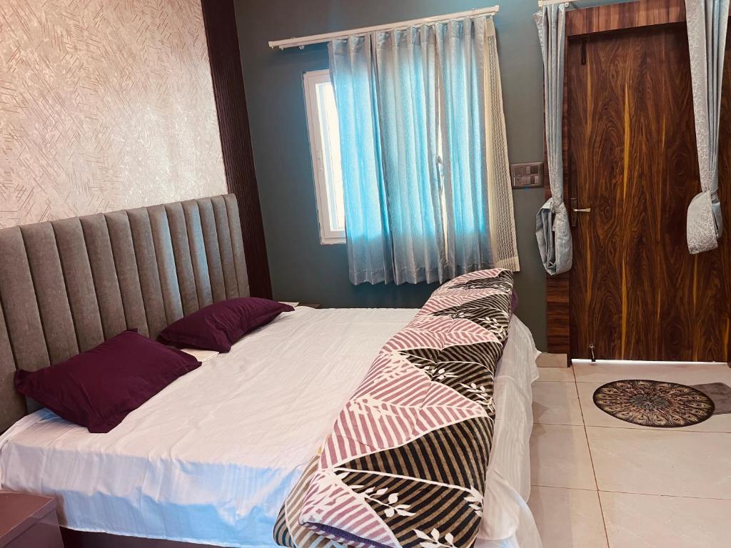 a bedroom with a bed and a window at Soar Serenity Homes in Pithorāgarh