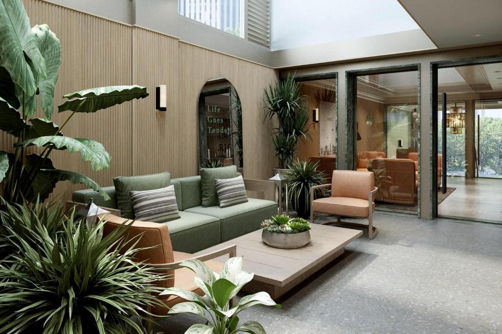 a lobby with a couch and chairs and plants at Little Charm Boutique Hotel in Hanoi