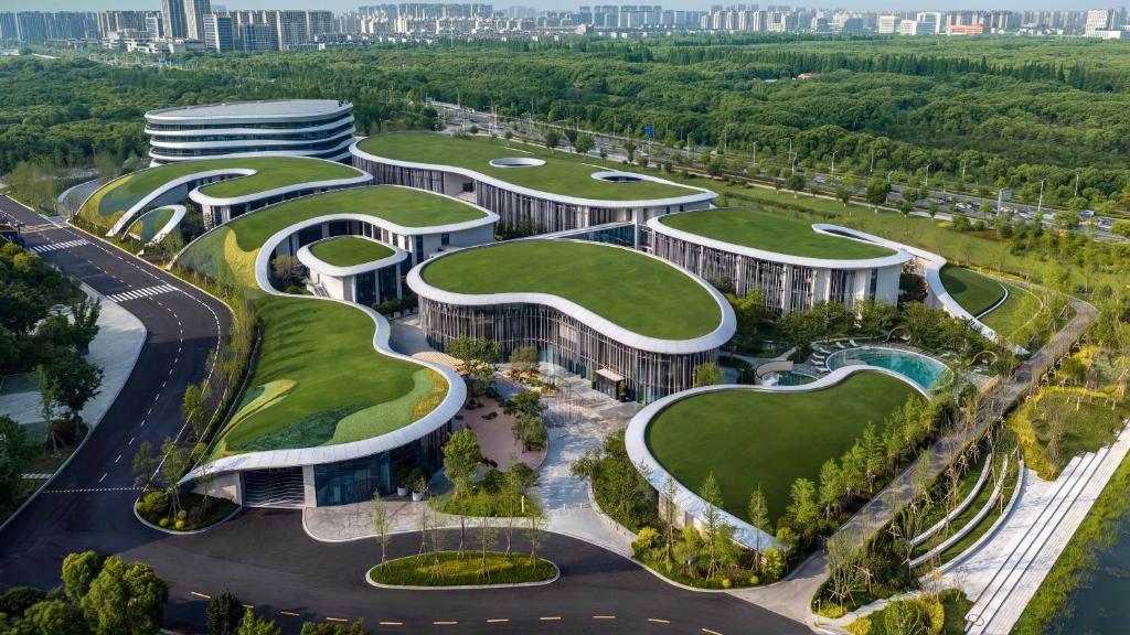 an architectural rendering of a building with curved roofs at Kimpton Nine Trees Shanghai by IHG in Shanghai