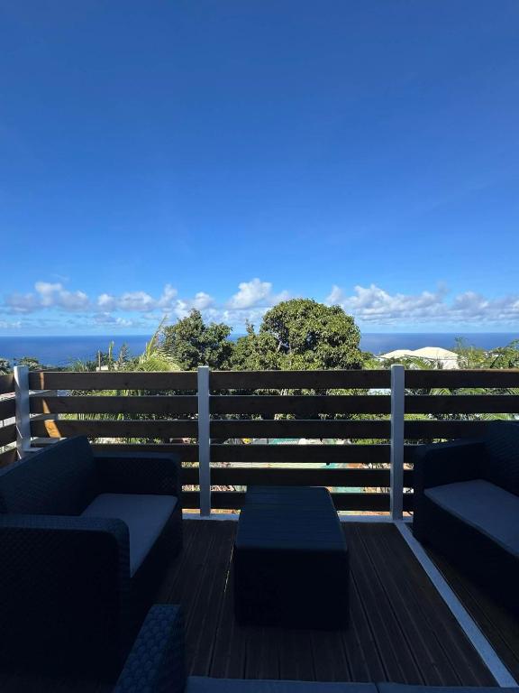 a deck with couches and a view of the ocean at La Cazatila in Petite Île