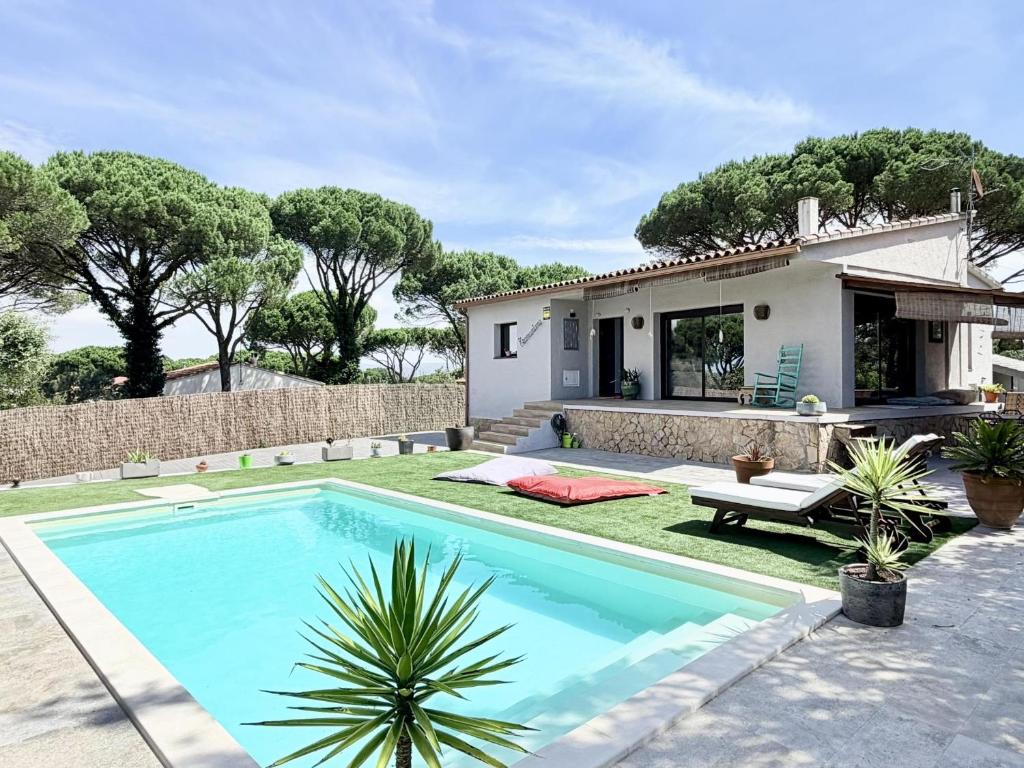 a villa with a swimming pool and a house at Villa Pins by Costabravaway in Llagostera