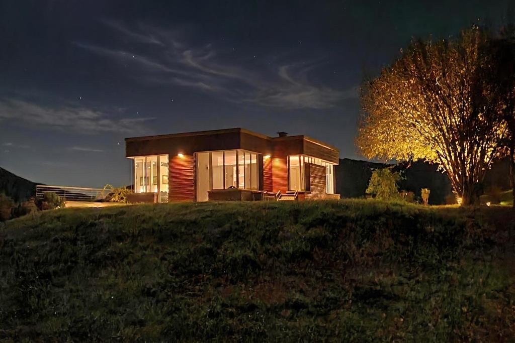 a small house on top of a hill at night at Villa Intelvi in Castiglione dʼIntelvi