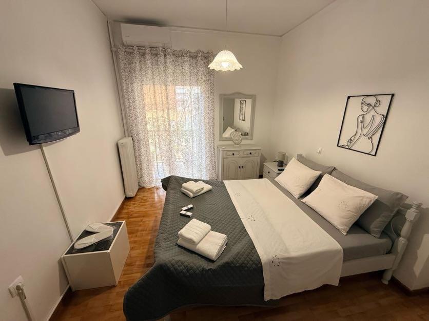 a bedroom with a large bed with two towels on it at KATERINA's House in Preveza