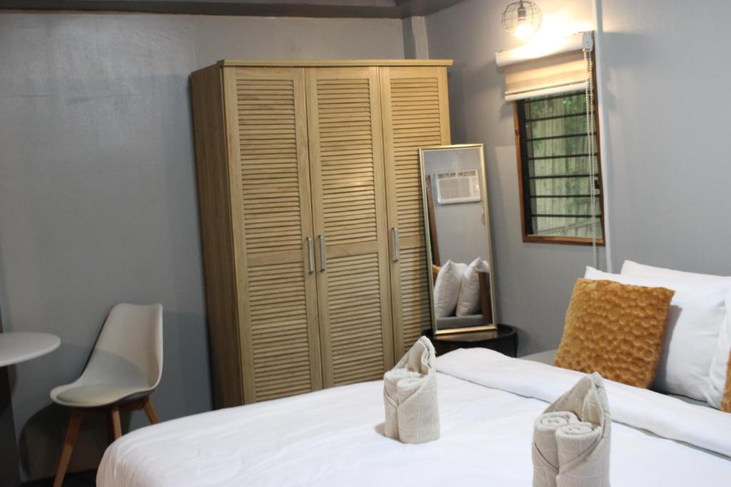 a bedroom with two beds and a large closet at Charlotte place in El Nido