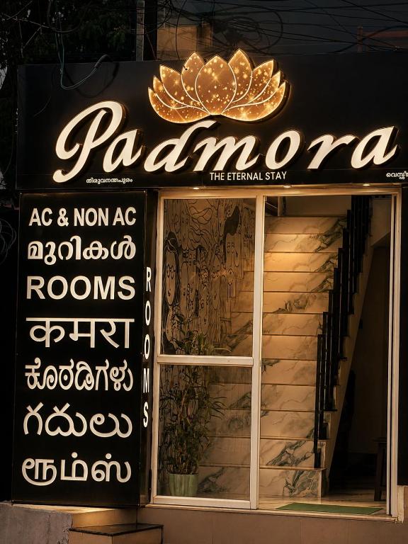 a store front with a sign for a restaurant at Padmora in Trivandrum