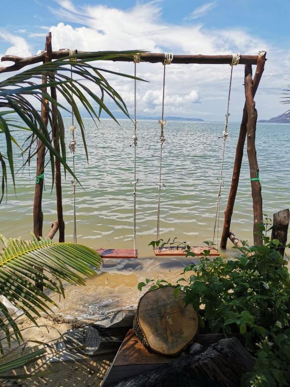 a swing on the beach near the water at Pornaree Hotel in Ban Pak Ba Ra