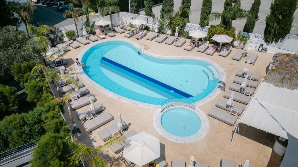 an overhead view of a swimming pool with lounge chairs and a resort at Gaia Sun N Blue Hotel in Ayia Napa