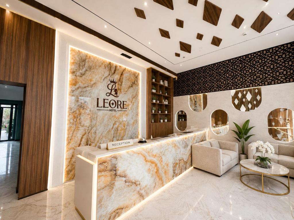 a lobby of a store with a large marble wall at Leore Hotel in Namangan