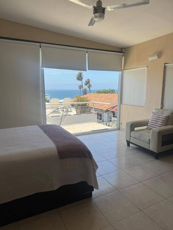 a bedroom with a bed and a view of the ocean at Beach house in San Miguel, Ensenada in Ensenada