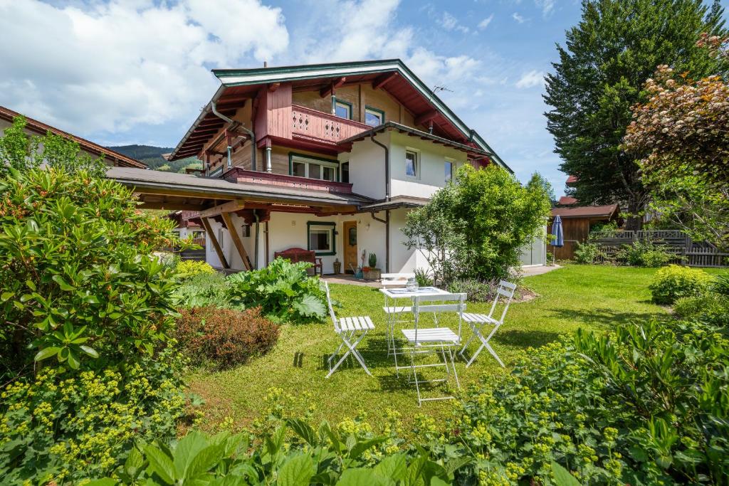 a house with a table and chairs in the yard at Haus Anna in Kirchberg in Tirol
