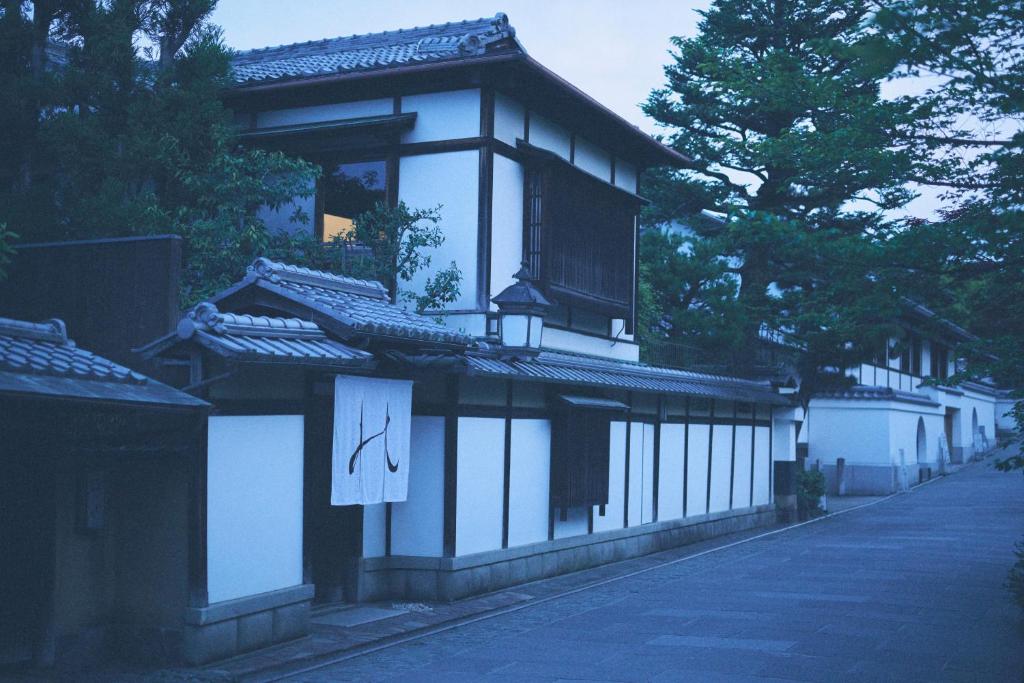 a building with a sign on the side of it at The Villa Nene-no-Michi Kazeno Heritage formerly HOTEL VMG RESORT KYOTO Nene in Kyoto