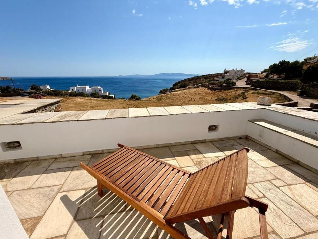 a wooden bench sitting on top of a roof at Rosalie Home - Aegean Poseidon in Tinos