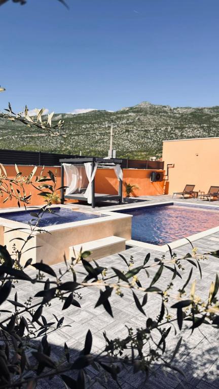 a flock of birds flying over a swimming pool at Villa Hercegovački raj Elf in Blagaj