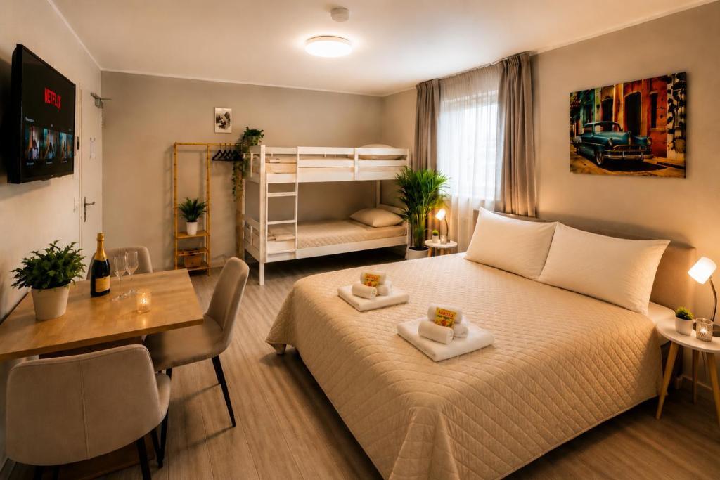 a bedroom with a bed and a desk and a bedroom with a bunk bed at Prime Apartment Hotel in Nuremberg
