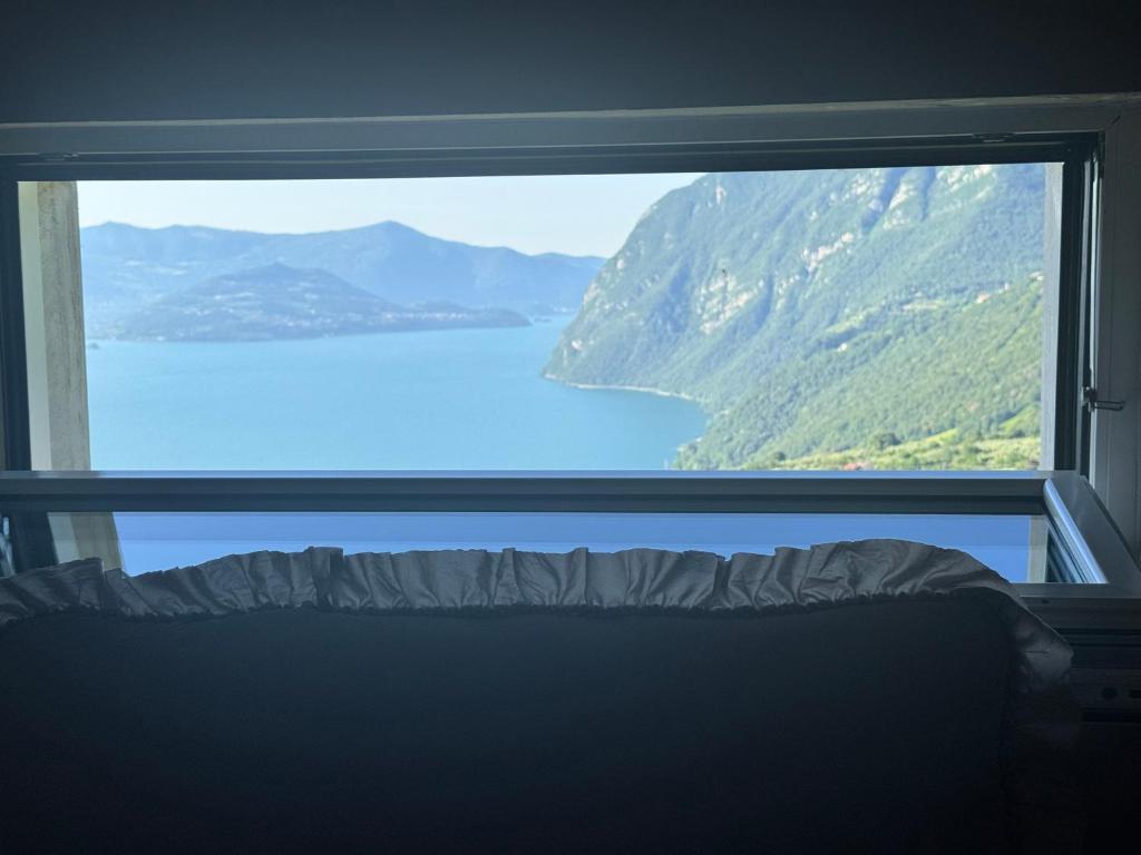 a view of a lake from a window at da rifare 1 in Solto Collina
