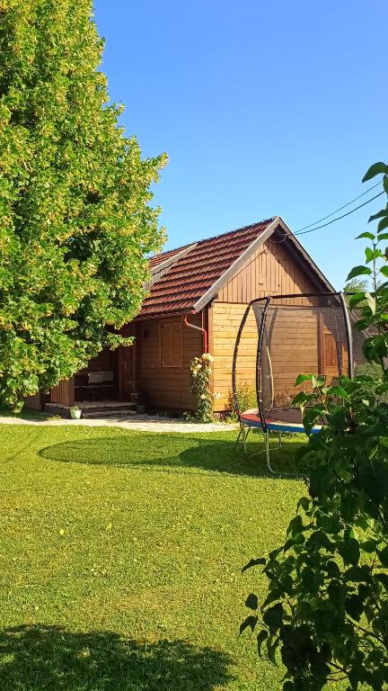 a house with a gazebo in the yard at House Nela near Plitvice Lakes in Smoljanac