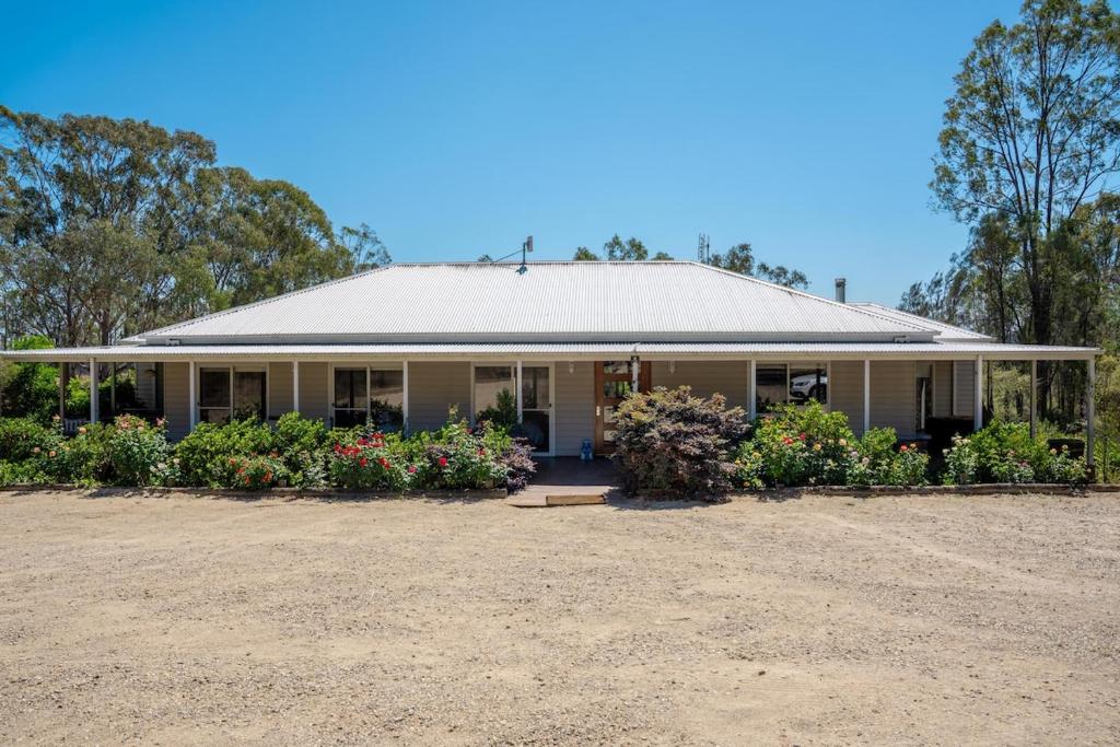 a house with flowers in front of it at Hunter Moon in Broke