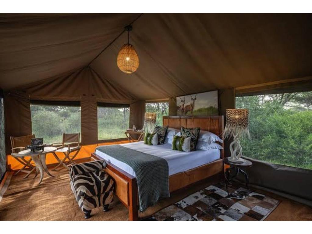 a bedroom with a bed in a tent at Mikumi Wilderness Camp in Kikoboga