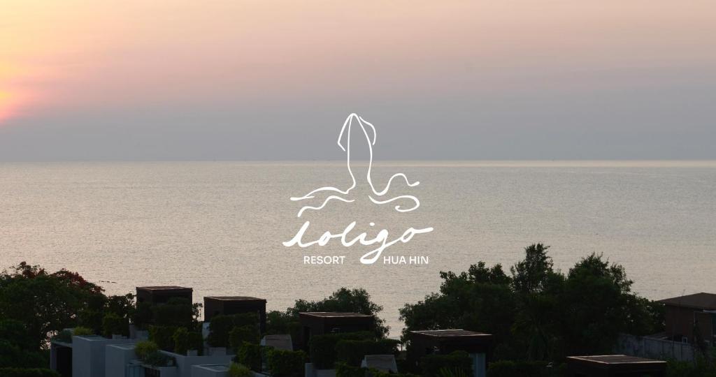 a logo for a beach resort in front of the ocean at Loligo Resort Hua Hin in Hua Hin