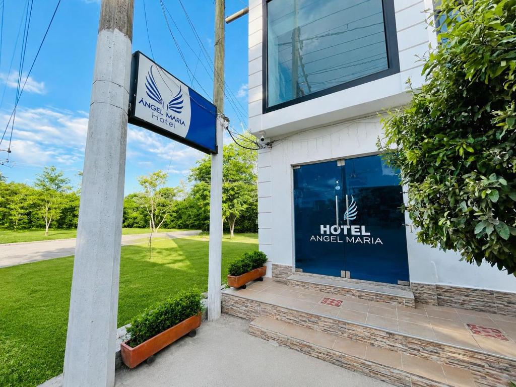 a hotel sign in front of a building at Angel Mari a Doradal in Doradal