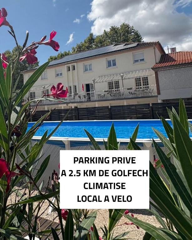 a sign in front of a house with a pool at Auberge de Lamagistere in Lamagistère