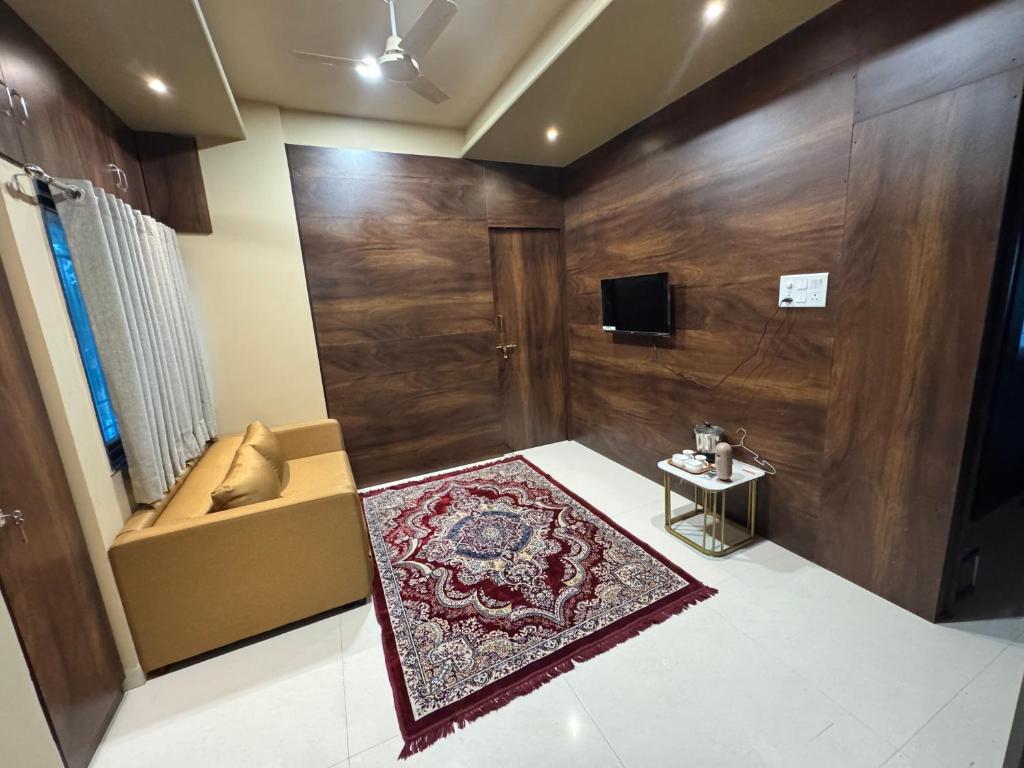 a living room with a couch and a rug at Ramona homestay in Kolhapur