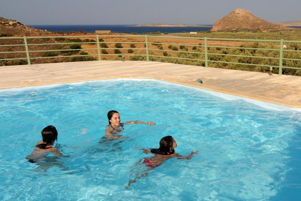 three women swimming in a swimming pool at Liostasi Country Houses in Palekastron