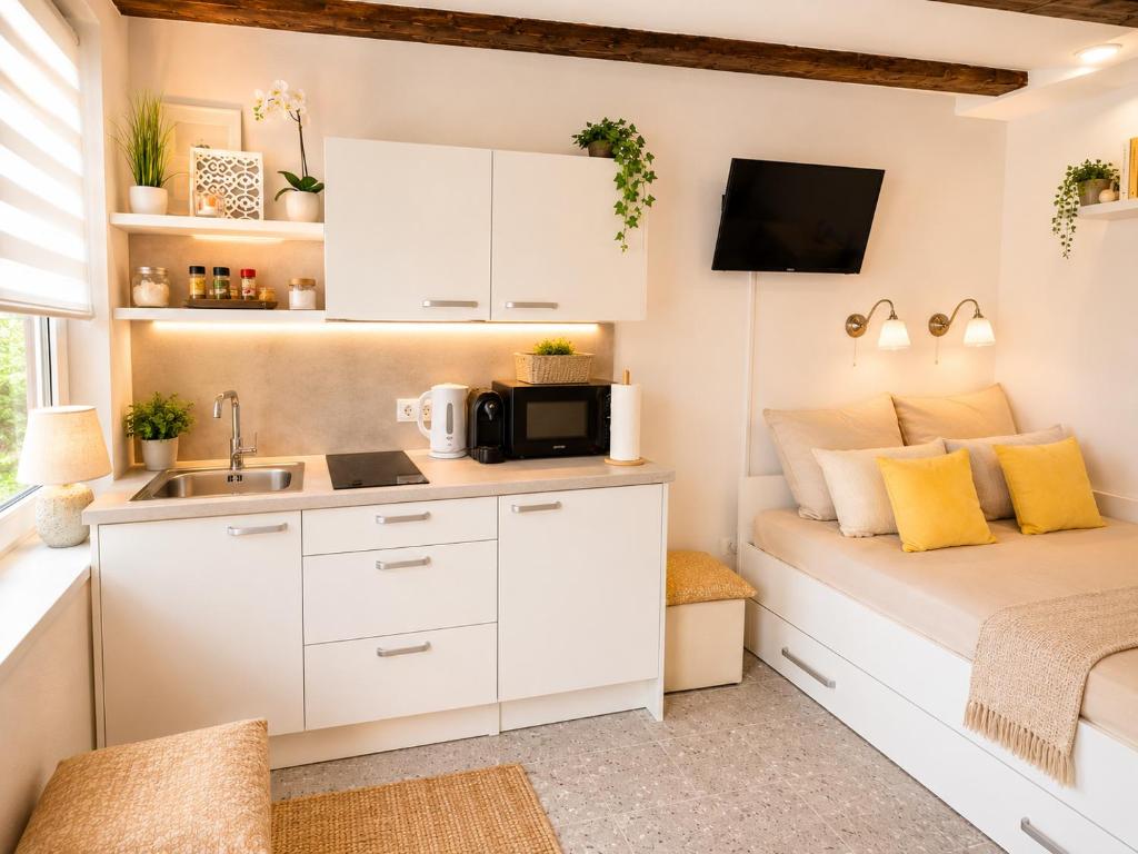 a small bedroom with a bed and a sink at Apartments Bella Tara in Piran