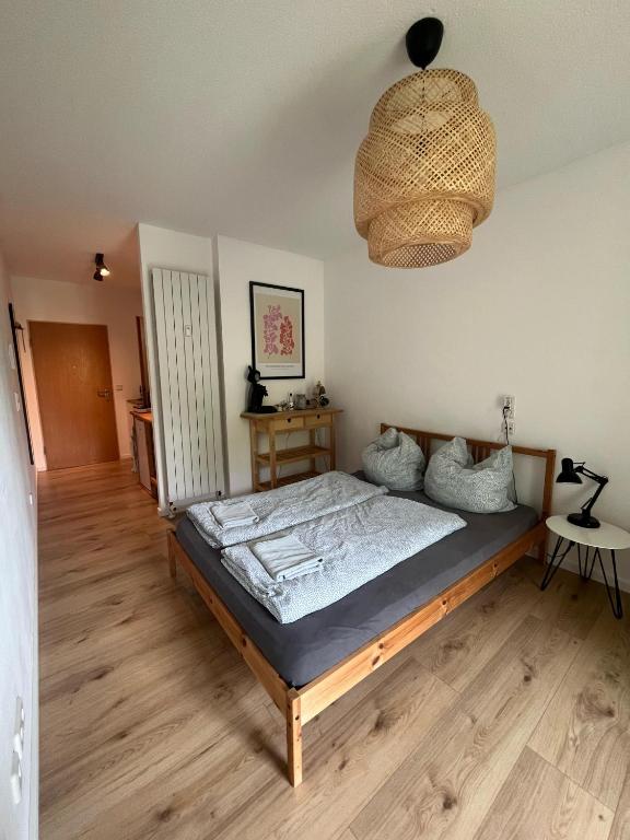 a bedroom with a bed and a chandelier at Schöne Wohnung in Passau in Passau