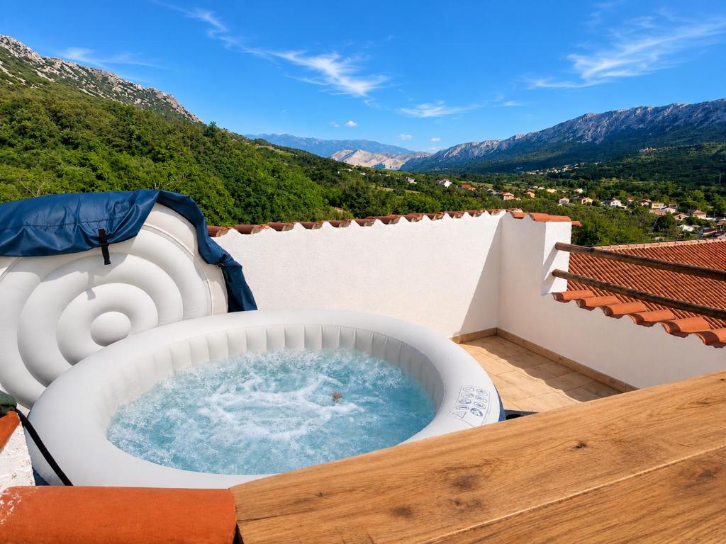 a jacuzzi tub on the balcony of a house at Sky Terrace retreat in Draga Bašćanska