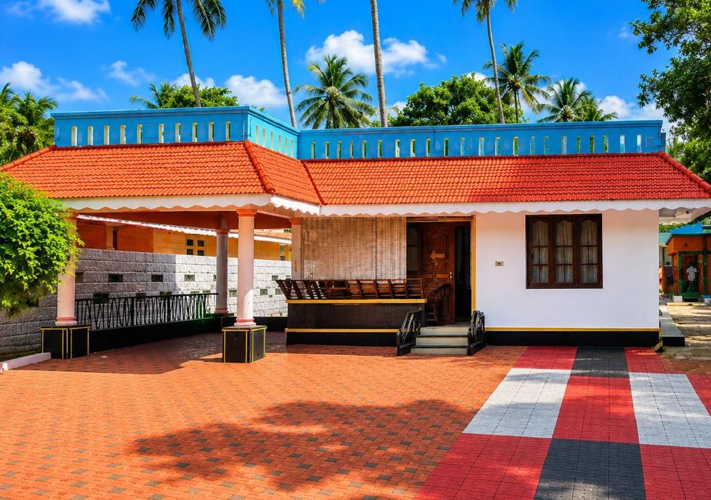 a building with an orange roof and a red roof at Sheen Villa Homestay in Varkala