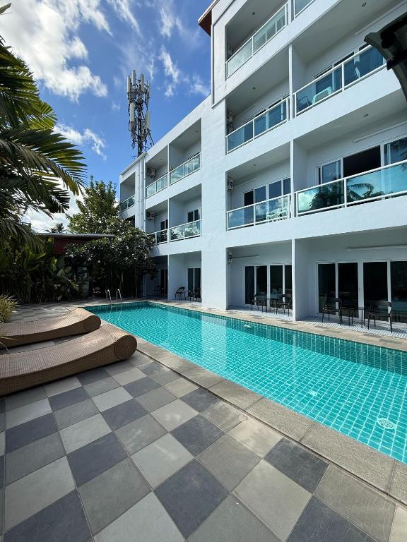 a swimming pool in front of a building at Big Buddha Hillside Hotel in Phuket