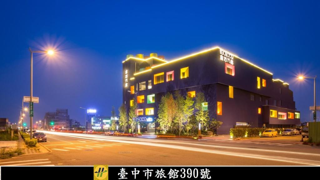 a building on the side of a street at night at Icolour Villa Motel in Taichung