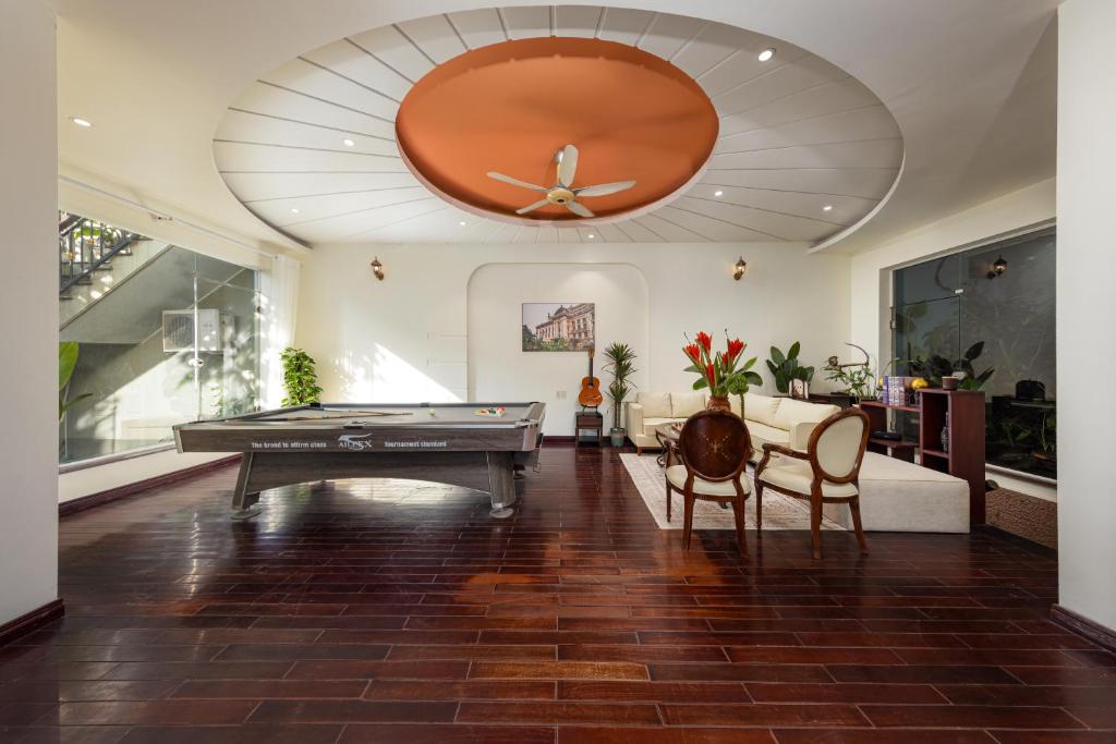 a living room with a pool table and a ceiling at Spacious 8BR Rooftop Jacuzzi Villa for Groups near West Lake in Hanoi