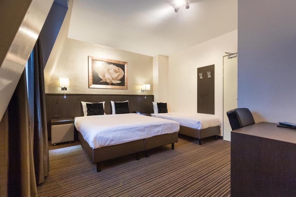Postel nebo postele na pokoji v ubytování Hotel de Duif Lisse - Keukenhof