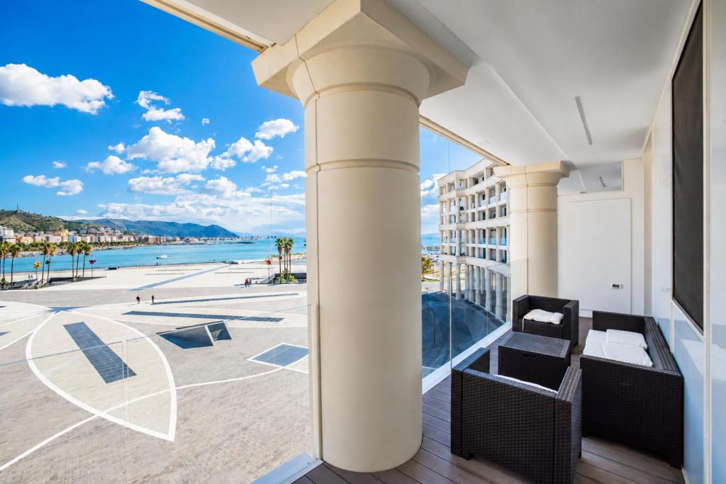 a balcony with a view of the beach at Crescent Luxury Retreat - Seafront Apartment Scala E in Salerno
