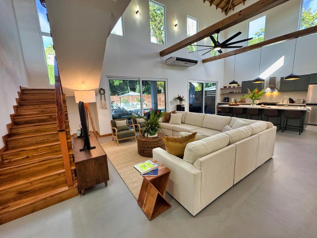 a living room with a white couch and a table at Casa Rivera - 4 Bedrooms in West Bay
