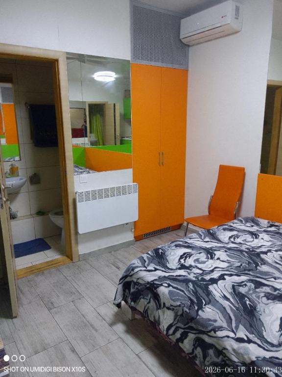 a bedroom with a bed and a sink and a mirror at Гостинка in Kharkiv