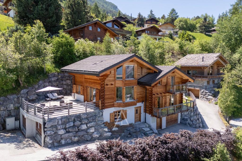 an aerial view of a log home with a mountain at Chalet Enchanteur in Nendaz