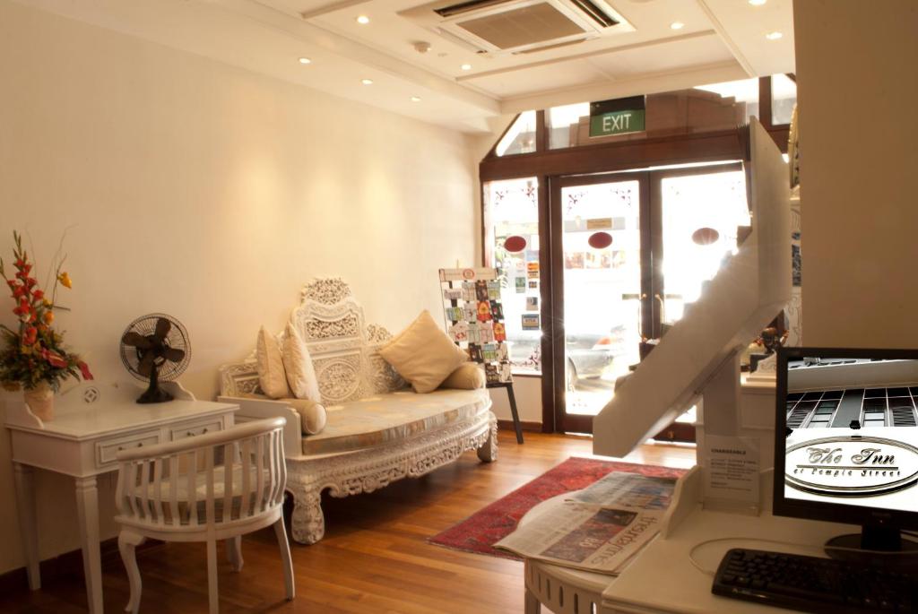 a living room with a couch and a table at The Inn at Temple Street in Singapore