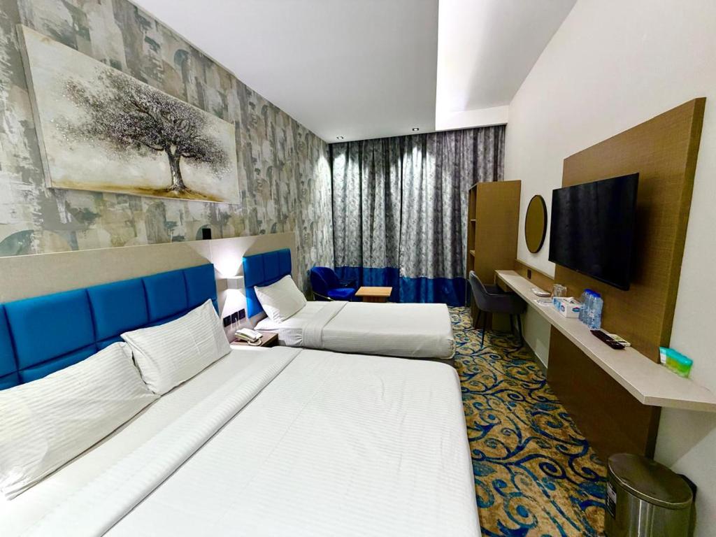 a hotel room with a bed and a tv at TAMARIND HOTEL in Dubai