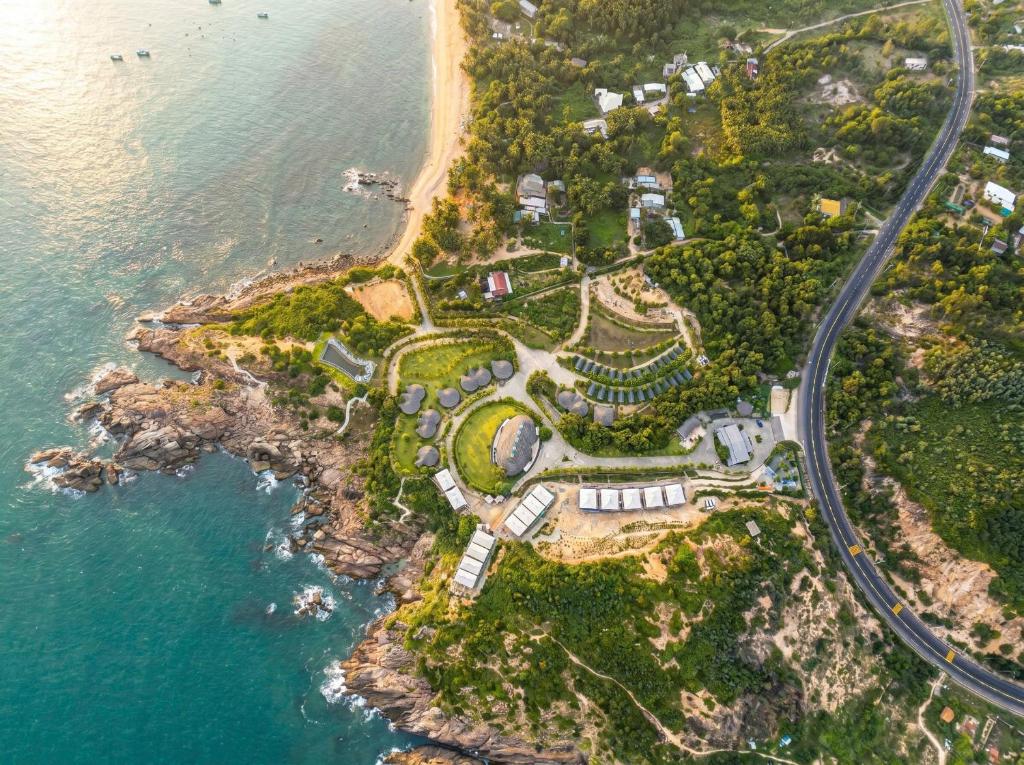 an aerial view of an island next to the ocean at Blue Haven Resort Quy Nhơn in Quy Nhon