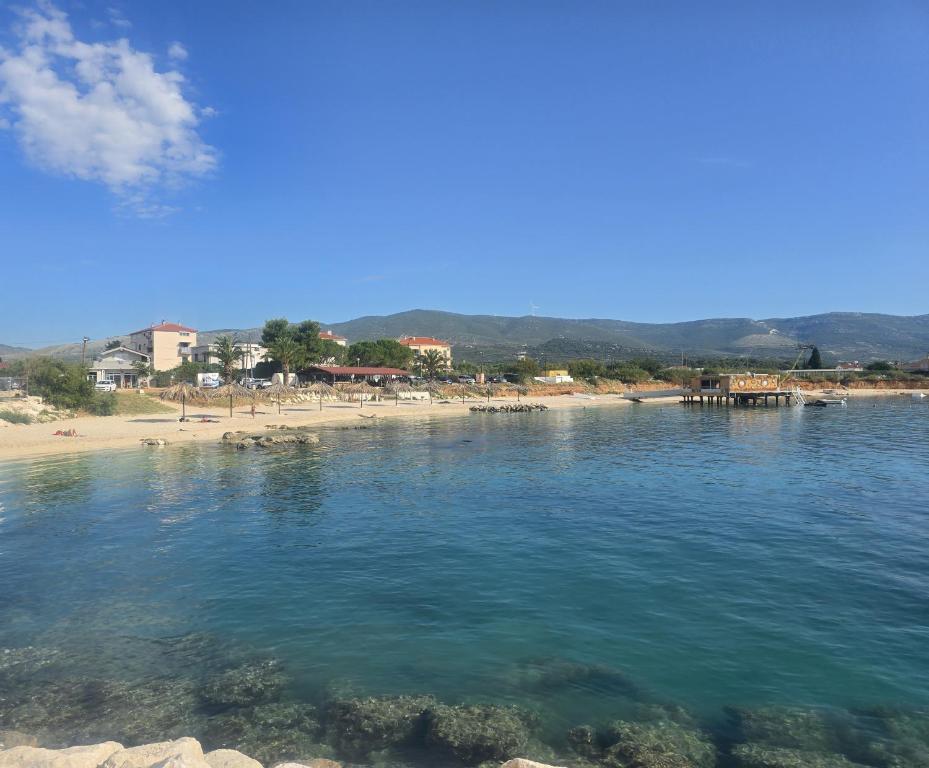 a body of water with a beach in the background at Airport Split in Kastel Stafilic