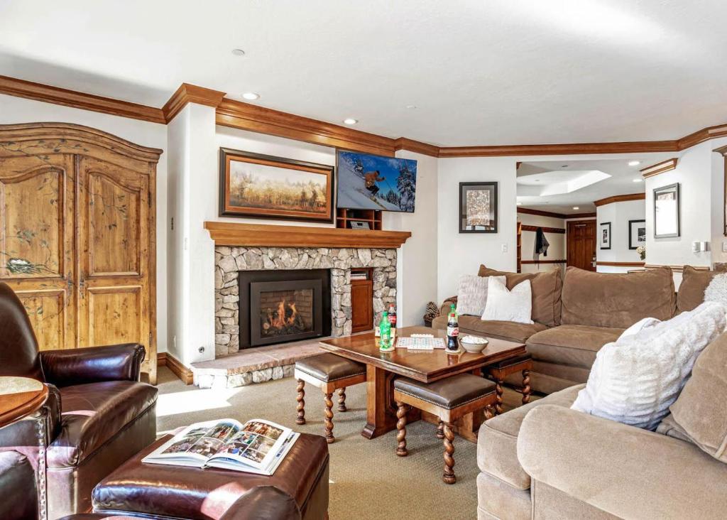 a living room with a couch and a fireplace at 323 Beaver Creek Lodge in Avon
