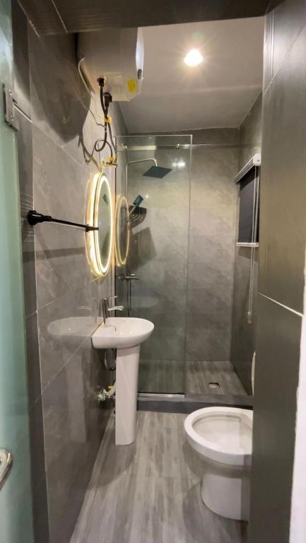 a bathroom with a sink and a toilet at Blu in Ikeja