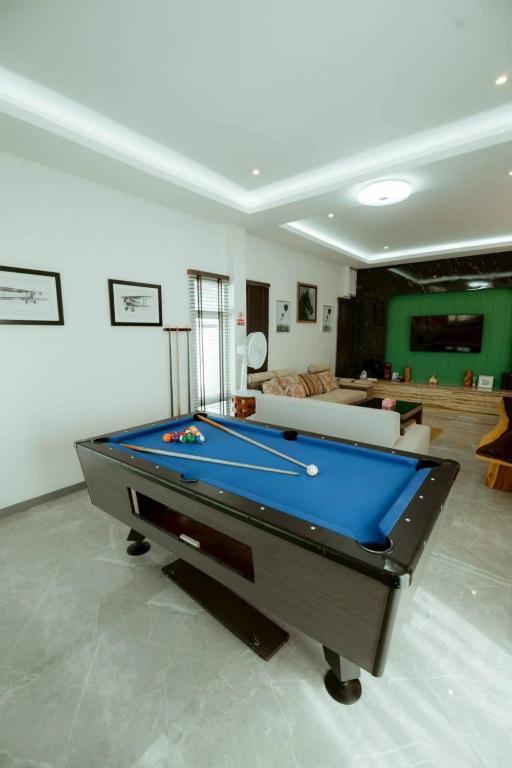 a living room with a pool table in it at V house 1 in Ban Huai Yai