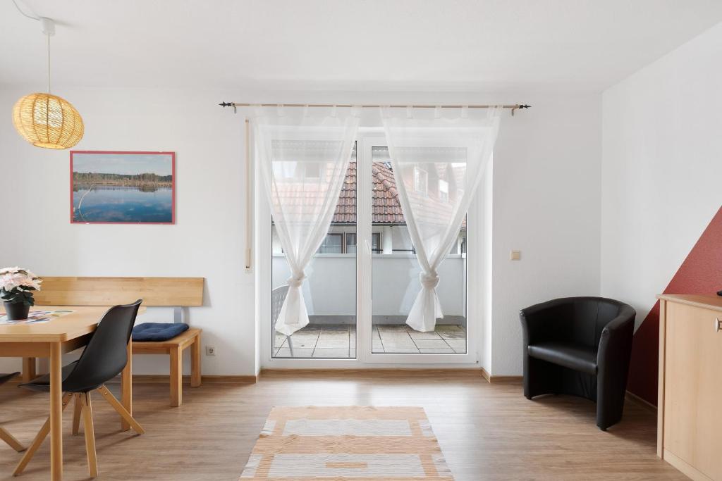 a living room with a table and chairs and a door at Apartment 45 in Bad Dürrheim