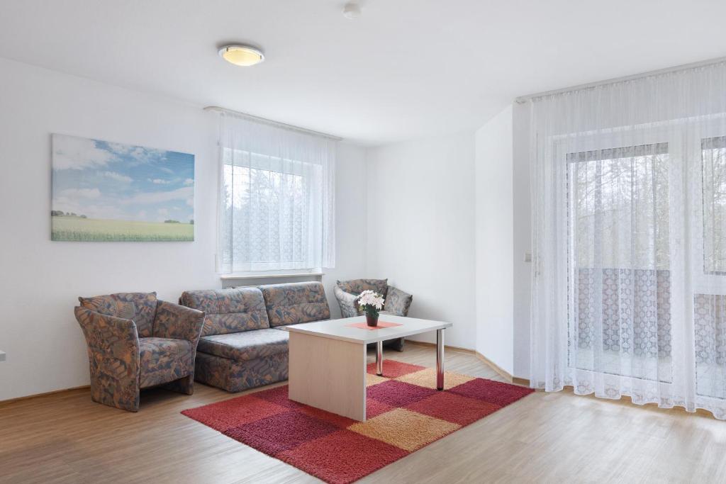 a living room with a couch and a table at Apartment 30 in Bad Dürrheim