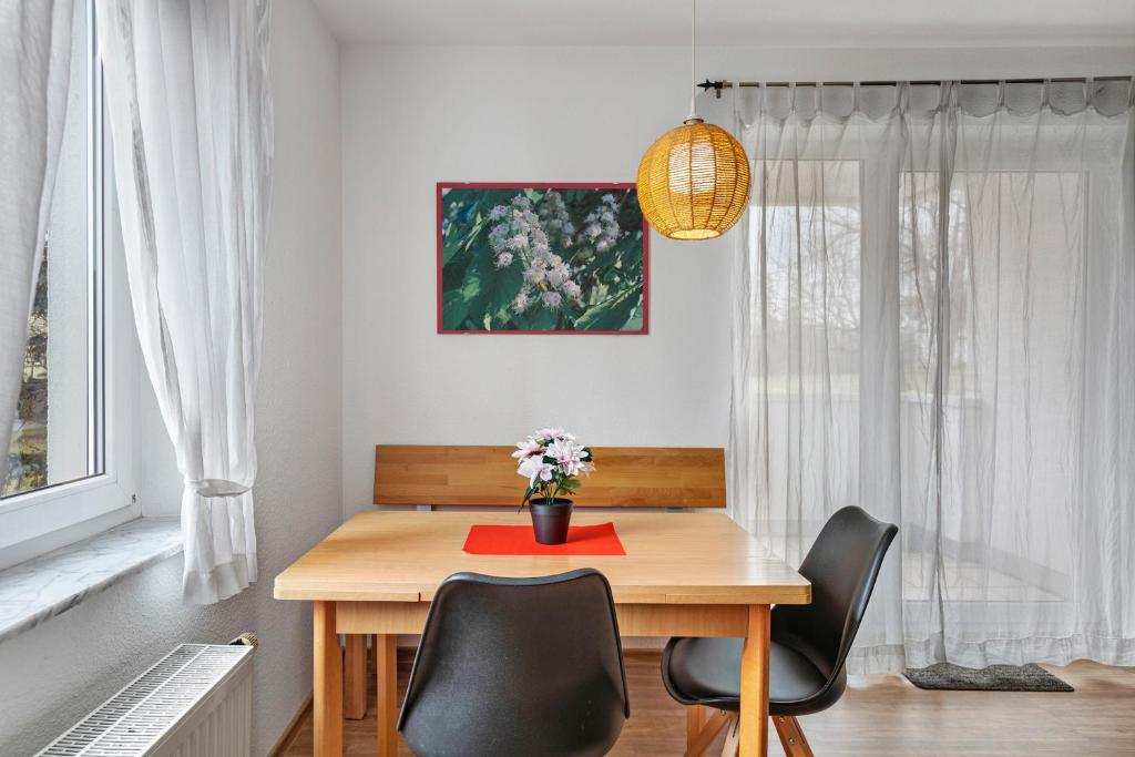 a dining room table with chairs and a red napkin at Apartment 47 in Bad Dürrheim